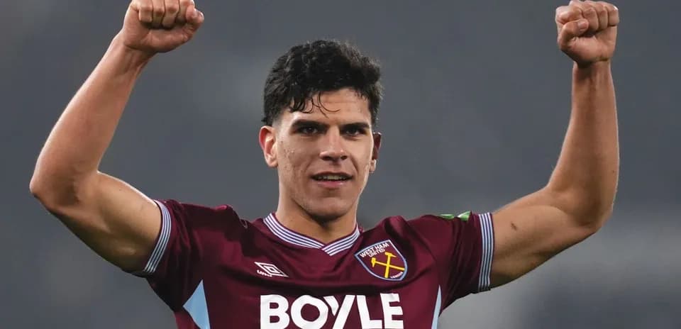 Player celebrating with raised fists in jersey