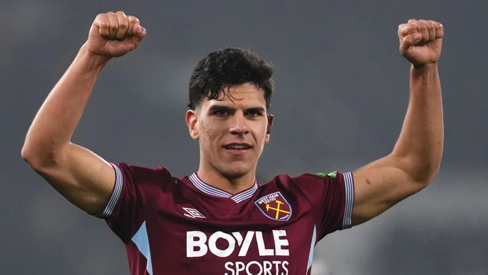 Player celebrating with raised fists in jersey