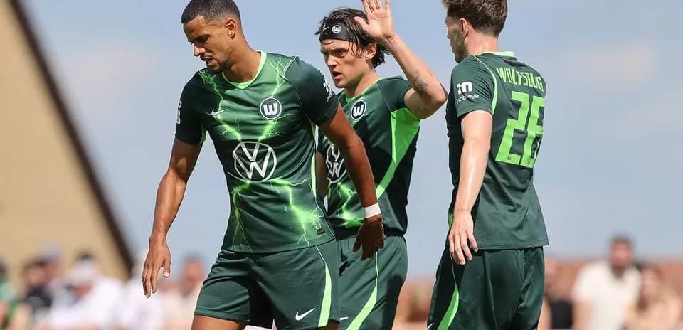 Wolfsburg players interacting during training session