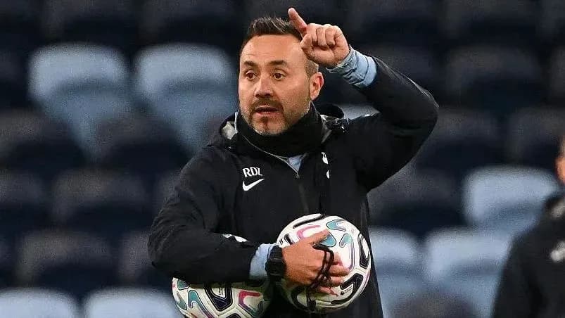 Coach giving instructions while holding soccer balls