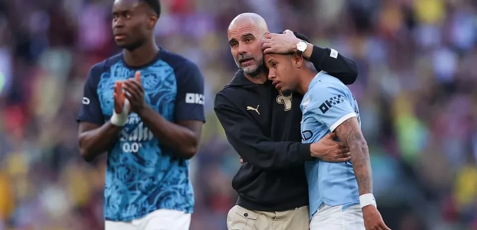 Manager comforting player after match on field