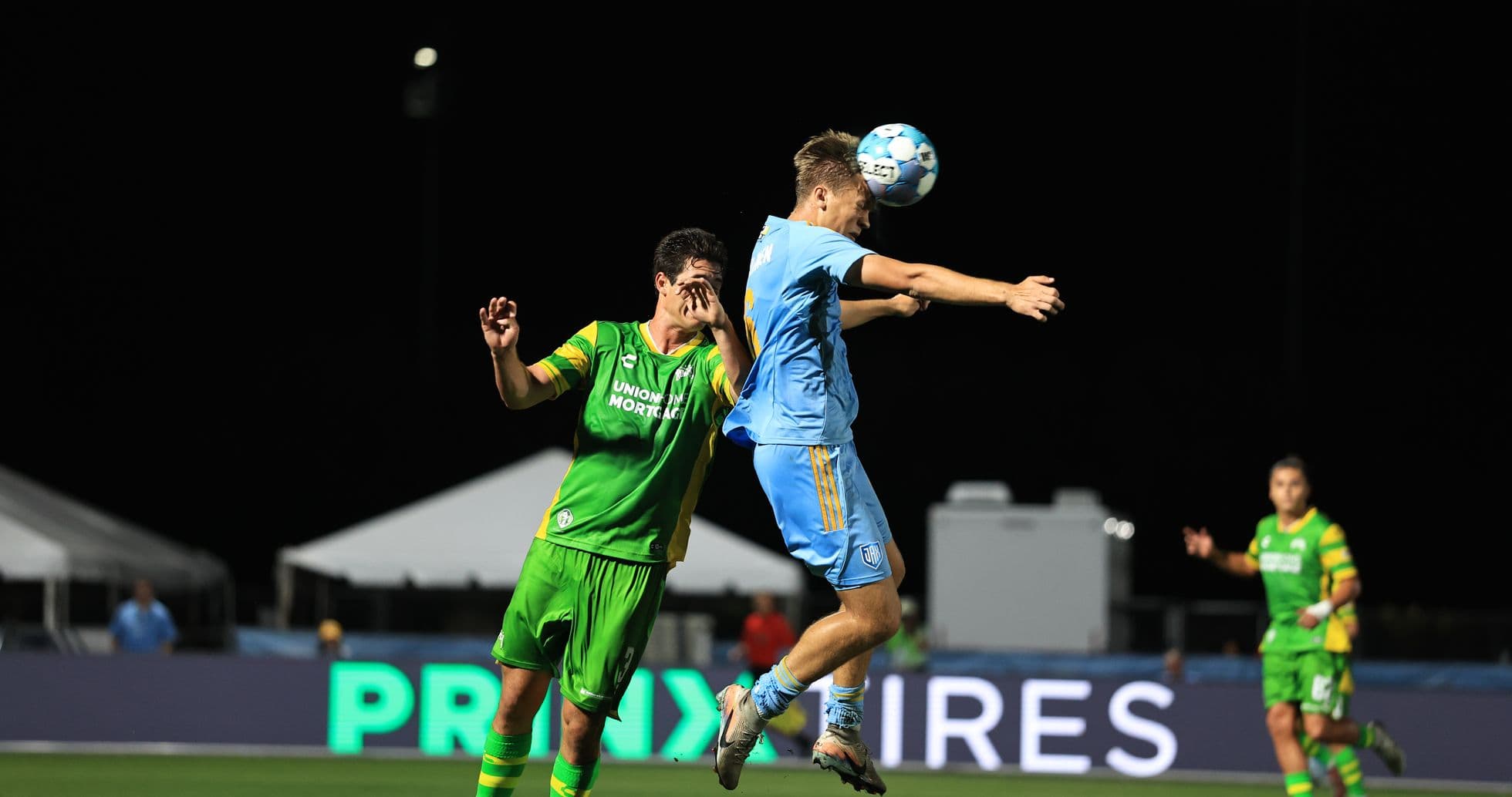 Player jumping for a header during match
