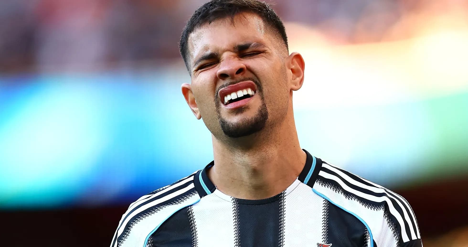 Player in Newcastle United kit reacting during match