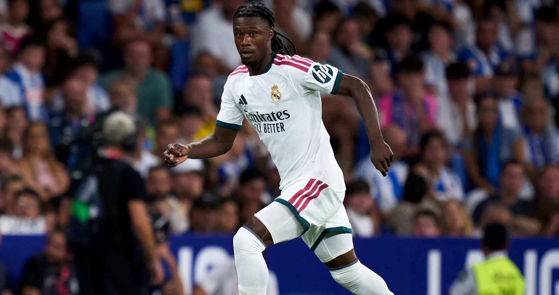 Player running during match wearing Real Madrid kit