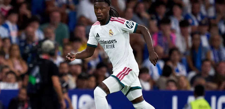 Player running during match wearing Real Madrid kit
