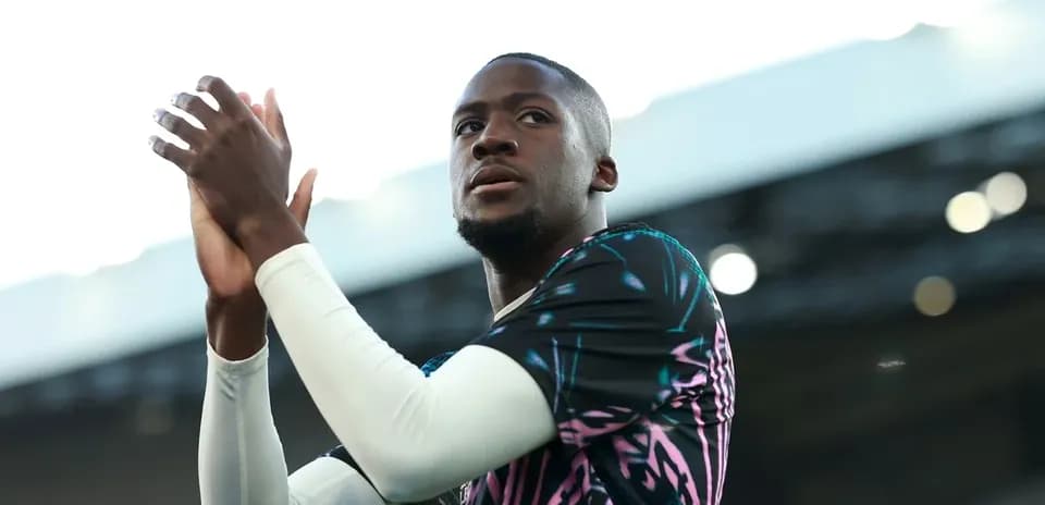 Player applauding fans in vibrant training kit