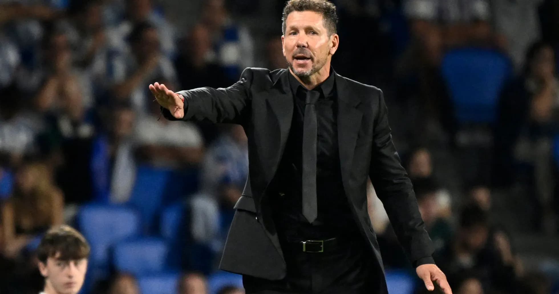 Coach gesturing during a football match on sidelines
