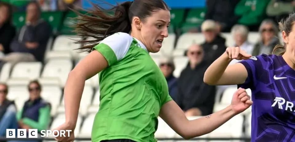 Player in green jersey dribbling the ball during match