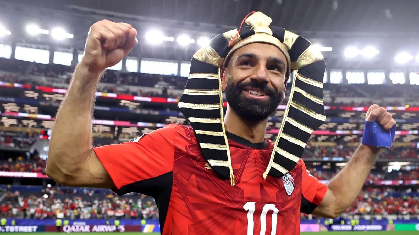 Player celebrating with Pharaoh headdress after match