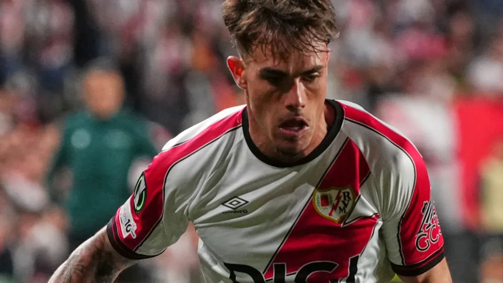 Player in Rayo Vallecano kit running during match