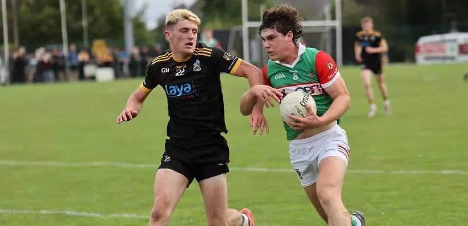 Two players competing for the ball in GAA match