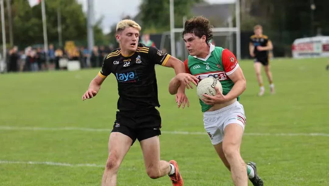 Two players competing for the ball in GAA match