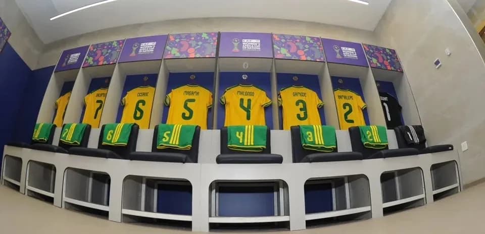 Football jerseys hanging in team locker room