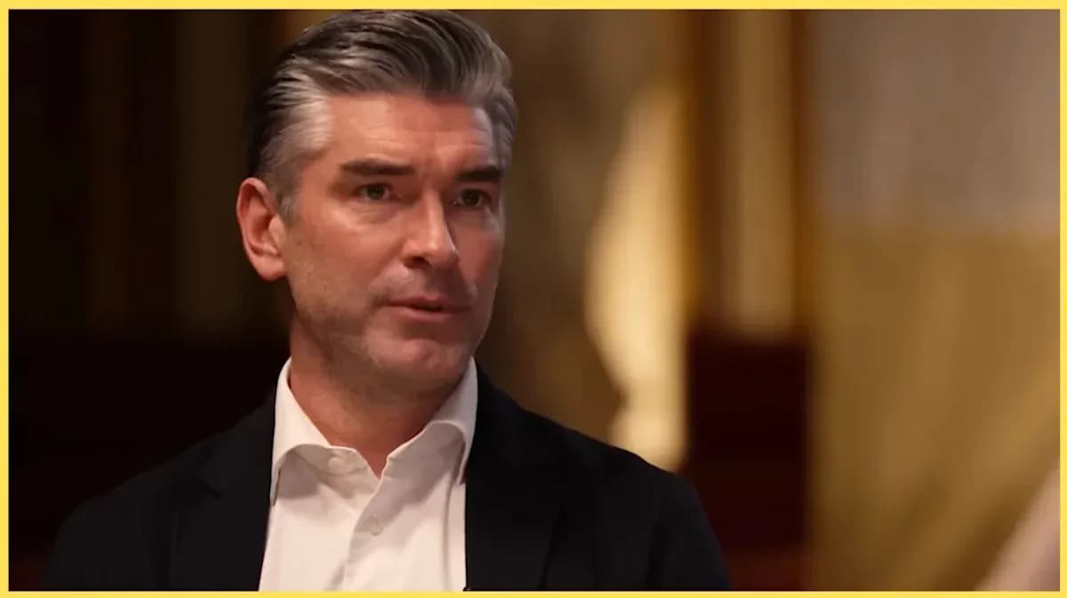 Man speaking during an interview in a formal setting