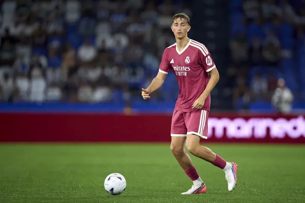 Player in pink jersey dribbling ball on field