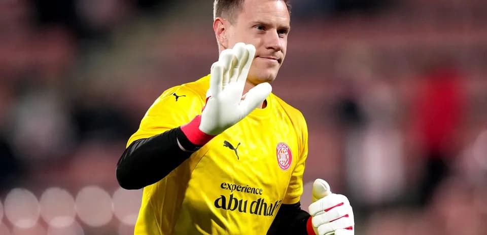 Goalkeeper in yellow kit waving to the crowd