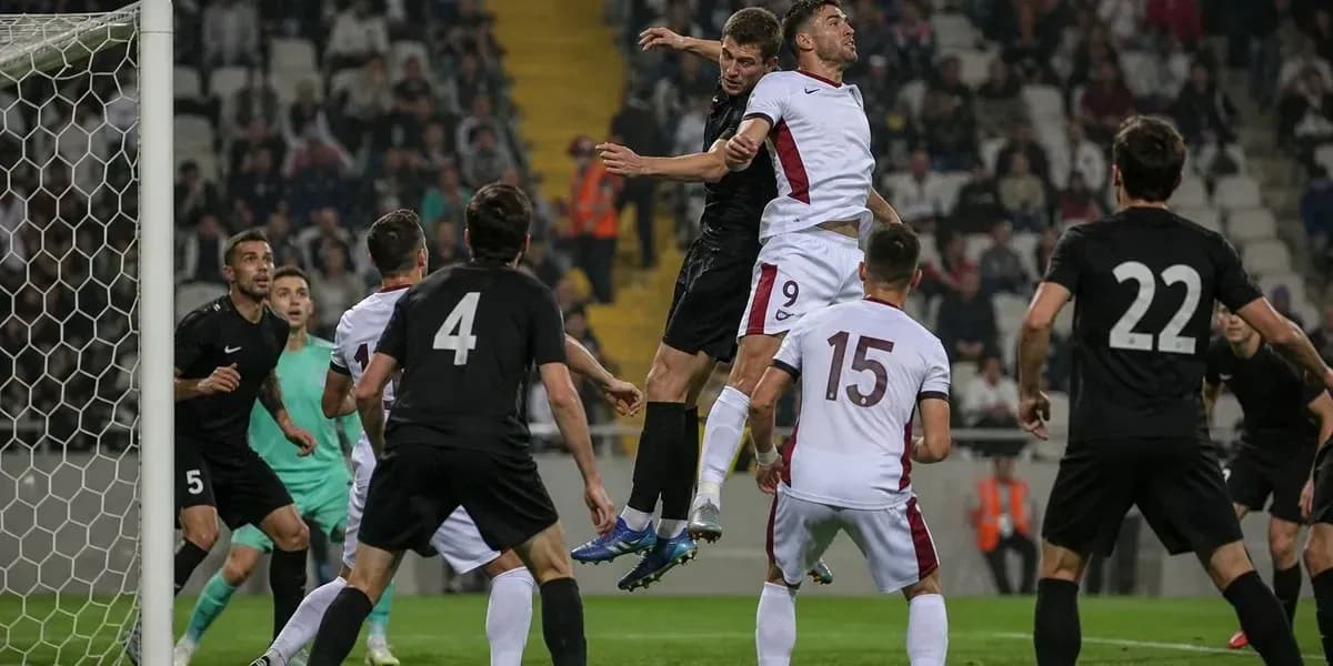 Players jumping for the ball near the goal