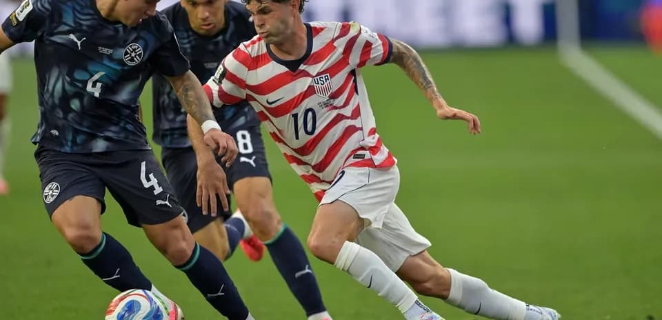 Player dribbling past defender during soccer match