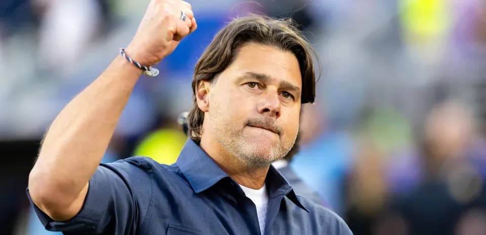 Coach celebrating with raised fist during match