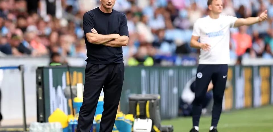 Coaches on sidelines during football match