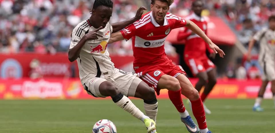 New York Red Bulls player tackling Chicago Fire opponent
