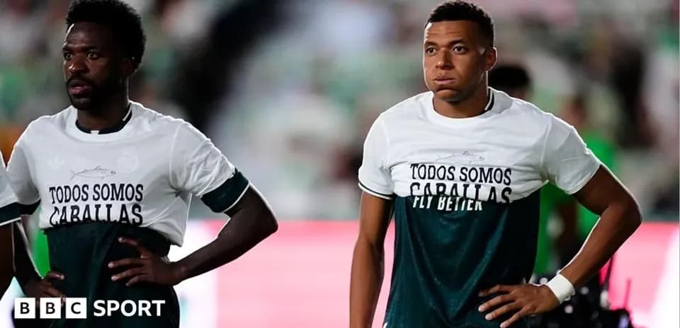Two players wearing matching shirts before the match