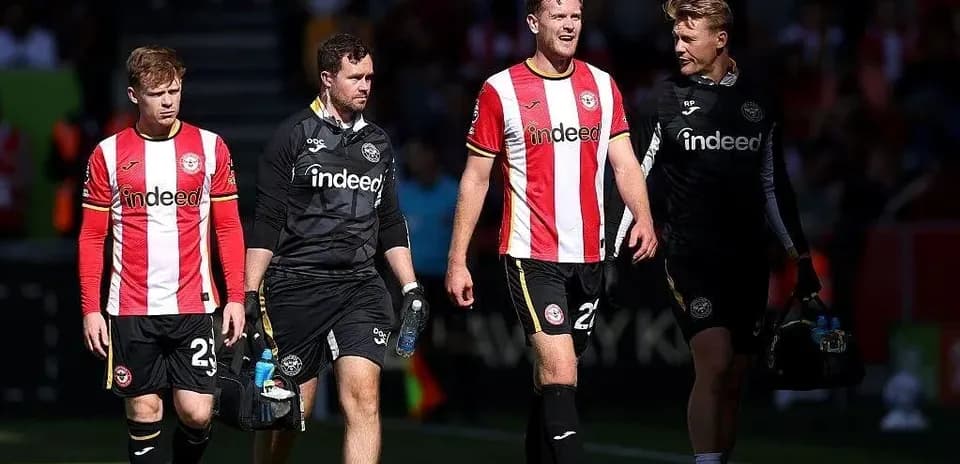 Brentford players and staff walking off the pitch