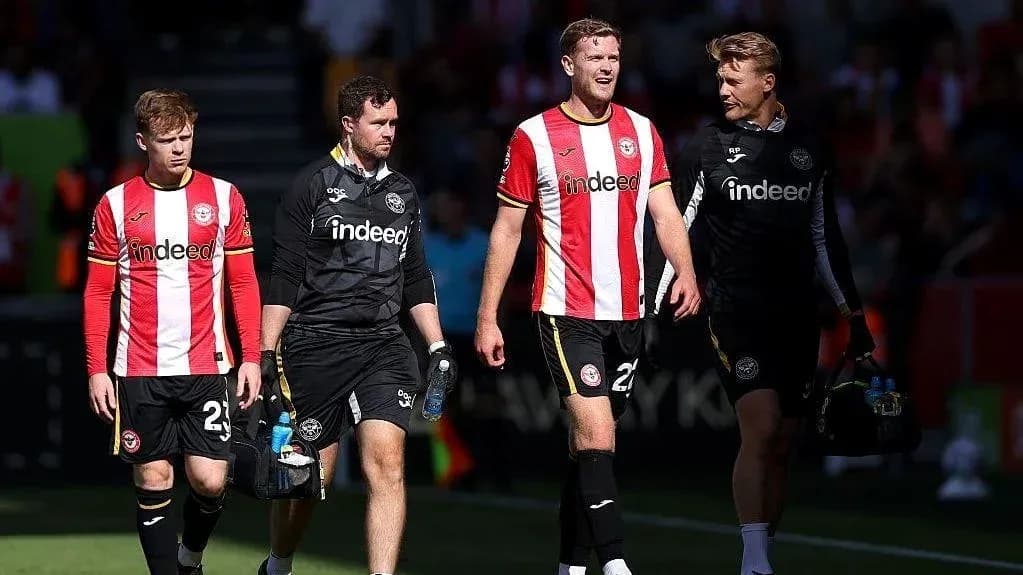 Brentford players and staff walking off the pitch
