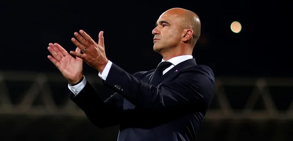 Manager applauding during a match on the sideline