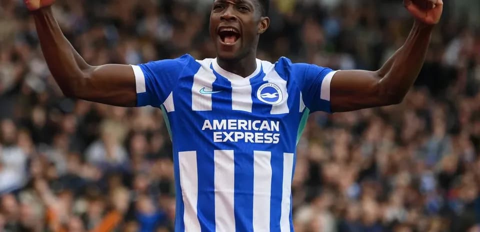 Player celebrating a goal wearing Brighton kit