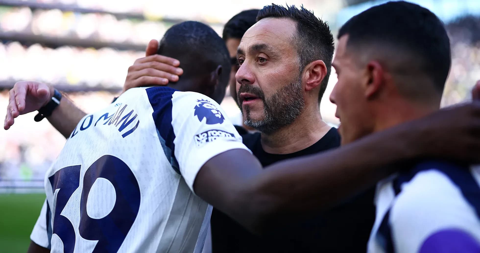 Player celebrating with coach after match