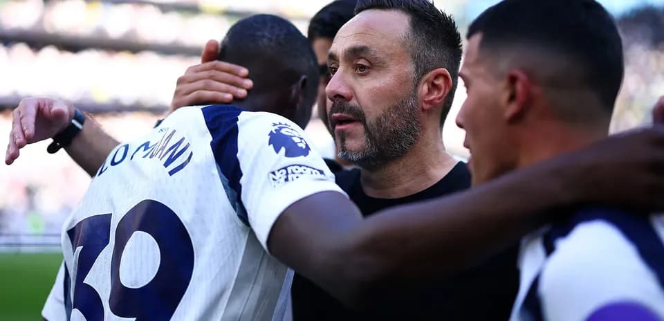 Player celebrating with coach after match