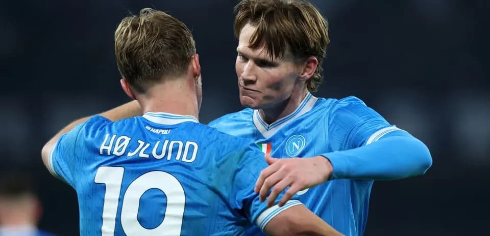 Two Napoli players embracing on the pitch
