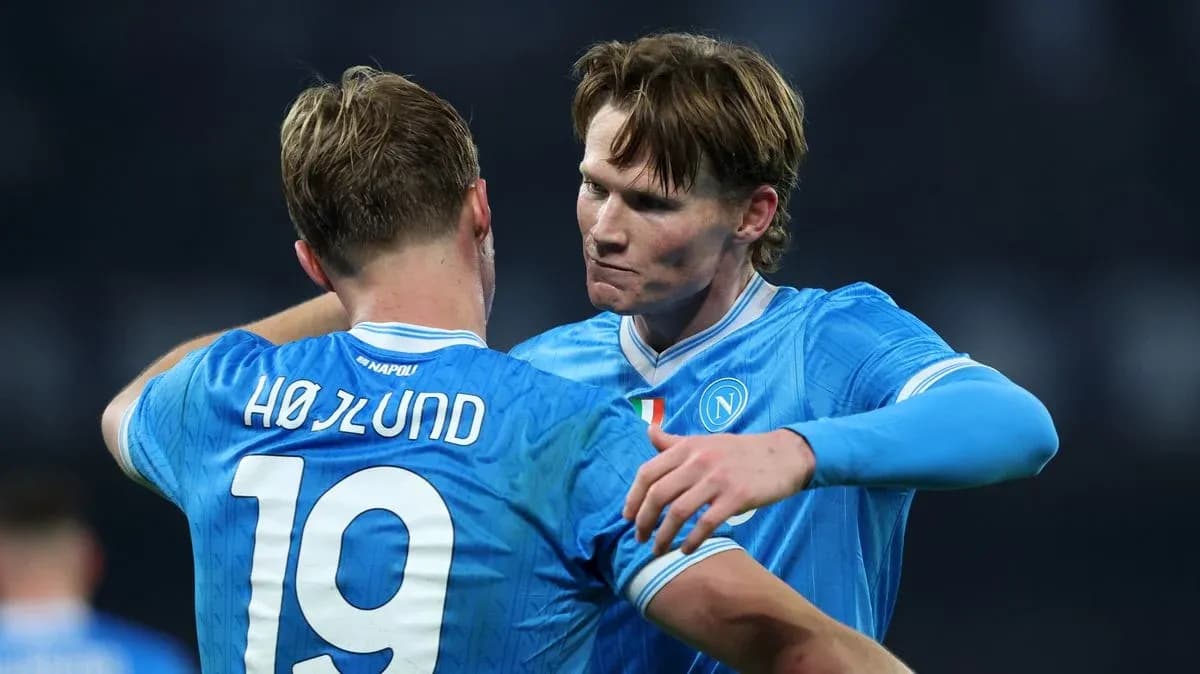 Two Napoli players embracing on the pitch