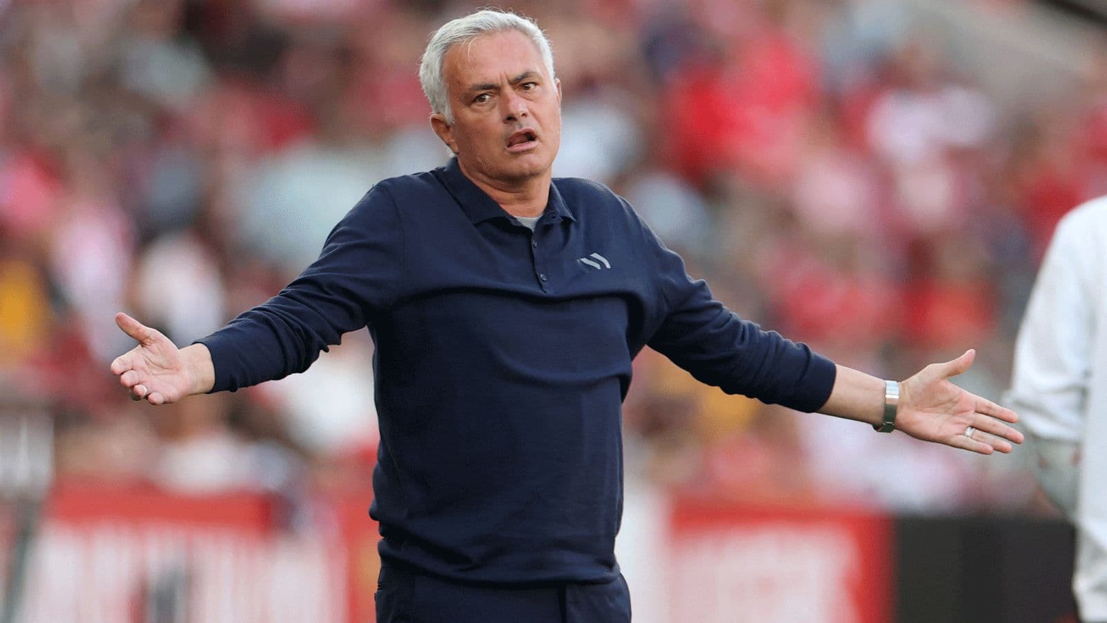 Manager gesturing on the sideline during match