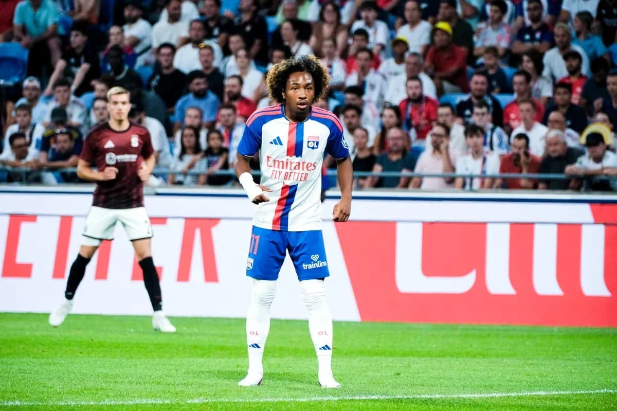 Player in OL kit during match with fans in background