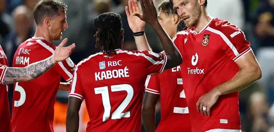 Players celebrating together in red team jerseys