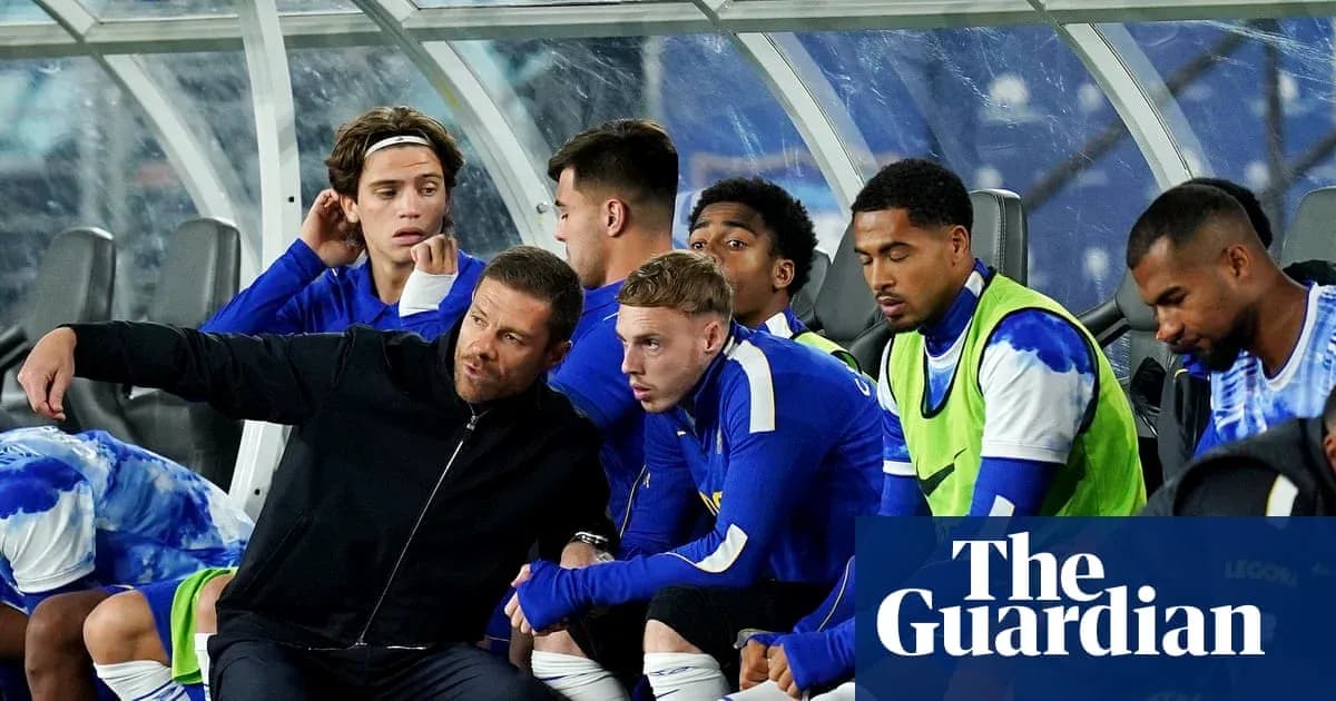 Coach discussing strategy with seated players on bench