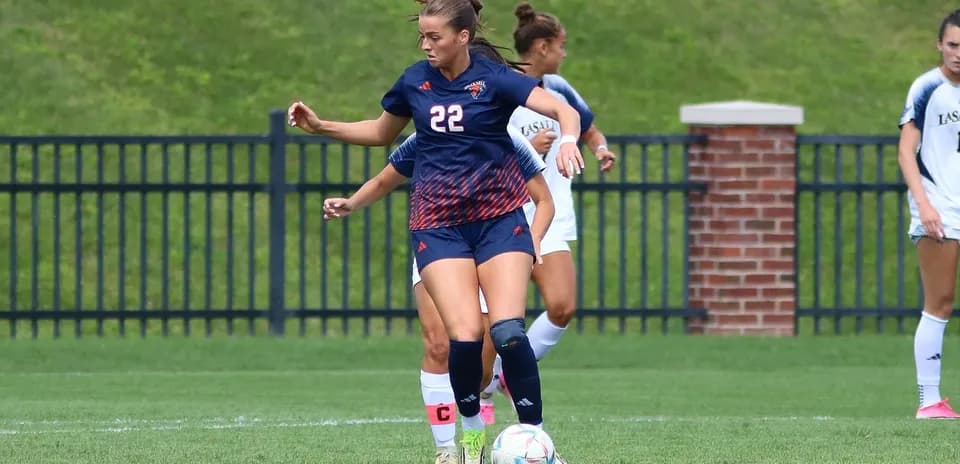 Player in blue uniform controlling the soccer ball
