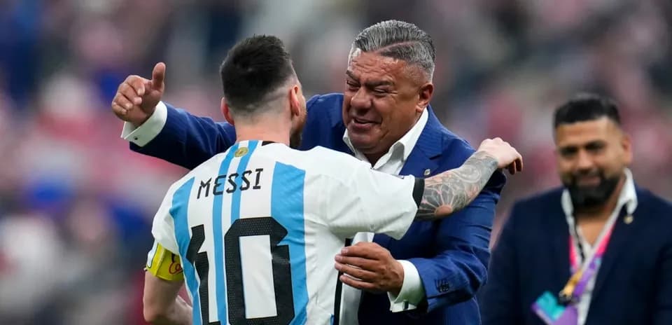 Lionel Messi embraces a coach after a match
