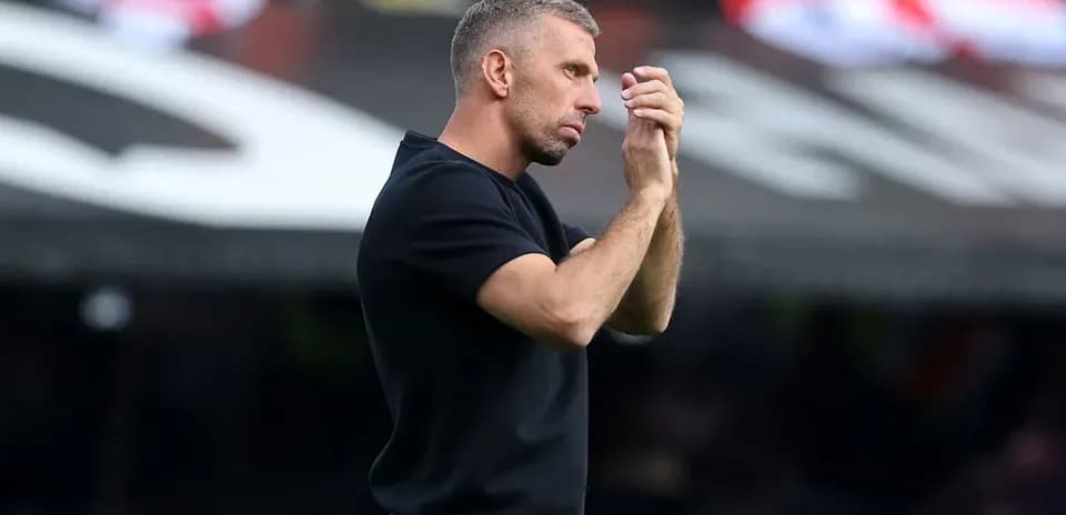 Coach observing the match with focused expression
