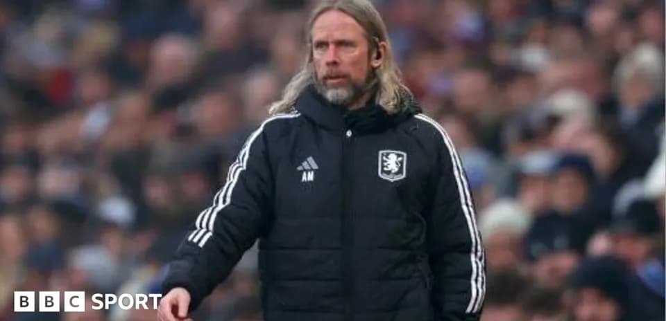 Manager in black jacket directing team during match