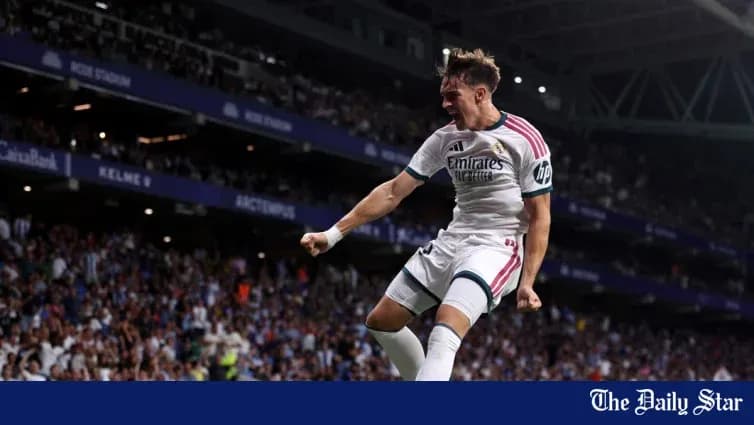 Player celebrating goal at stadium with fans