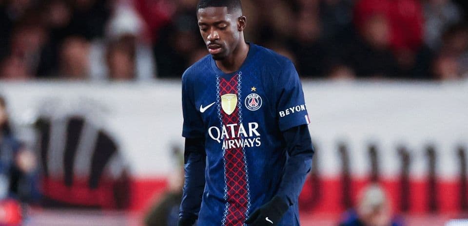 Player wearing PSG jersey walking on the pitch