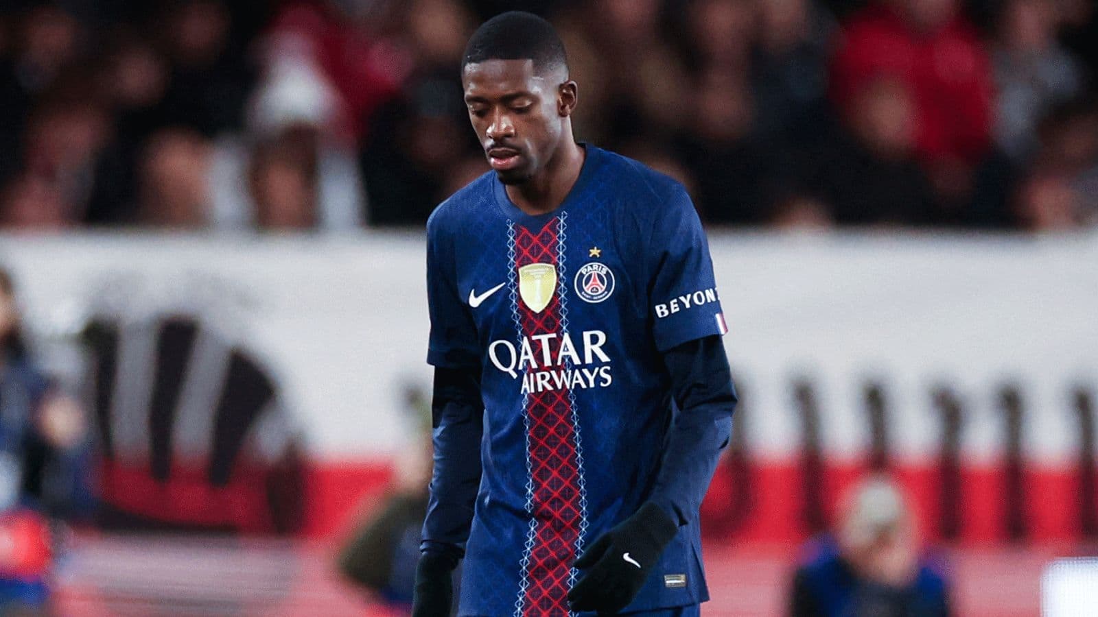 Player wearing PSG jersey walking on the pitch