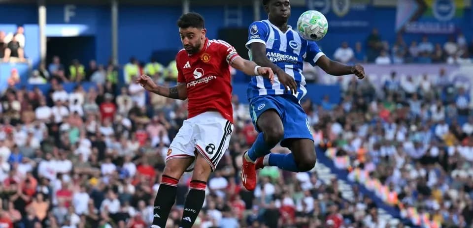 Player from Manchester United challenges Brighton player for ball
