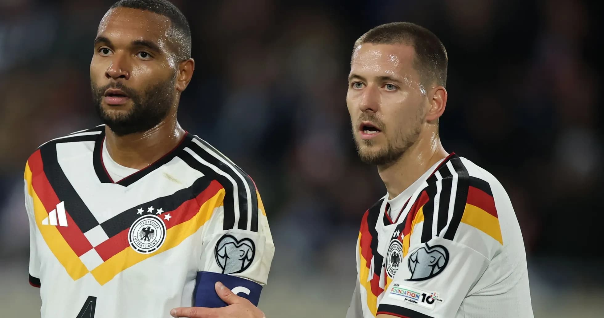 Two German players discussing during match