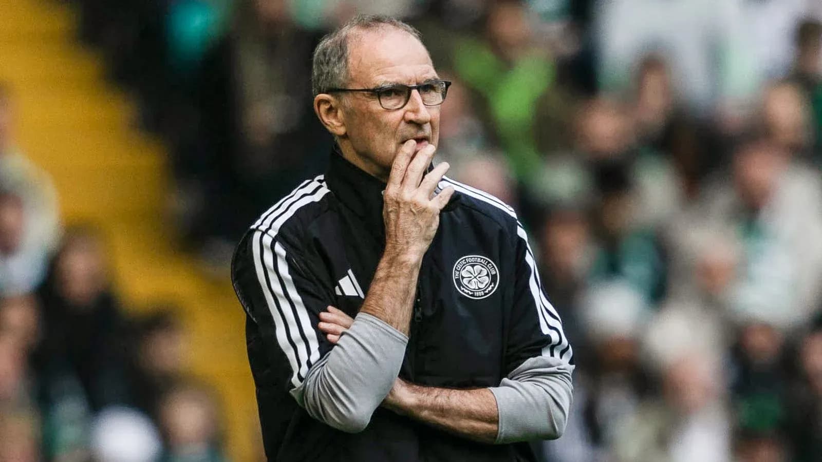 Coach observing the match with arms crossed