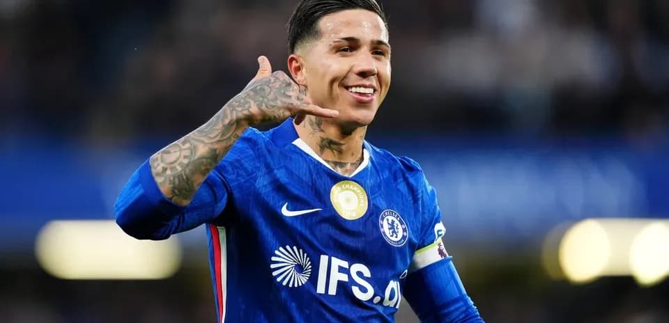 Player celebrating with a call gesture on pitch