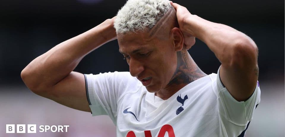 Player holding head in frustration on the pitch